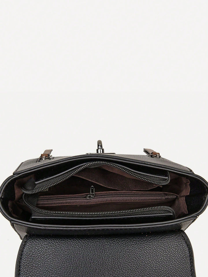 Open black pebbled leather handbag showing interior compartments, zippers, and dark brown lining against a plain white background.