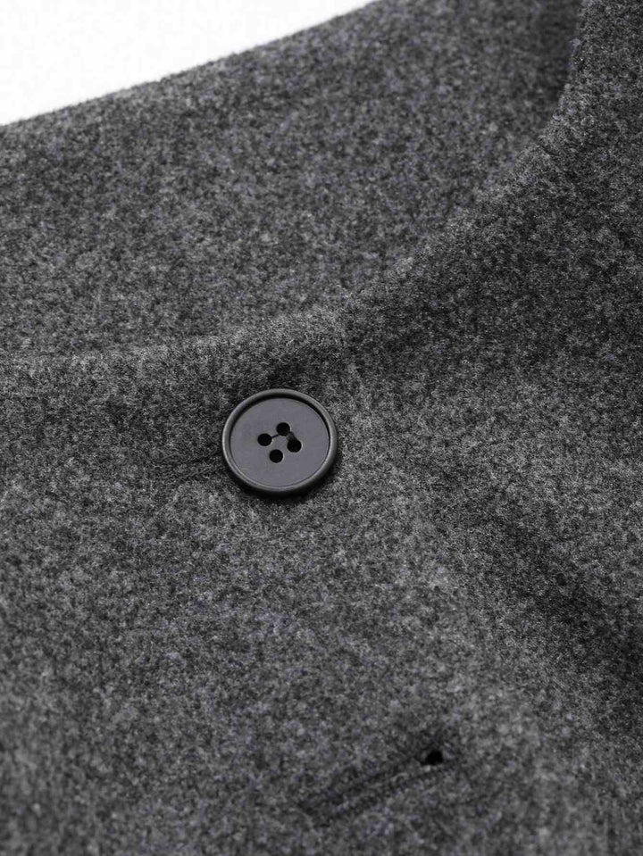 Close-up of a dark gray heathered wool or wool-blend garment with a black four-button closure.