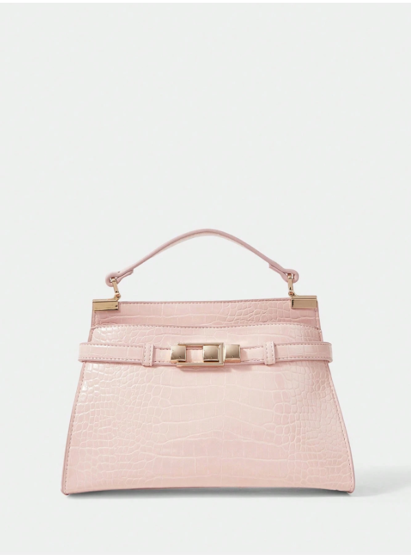 A light pink crocodile-embossed leather handbag with a structured top handle and gold-tone hardware, shown against a plain white background.